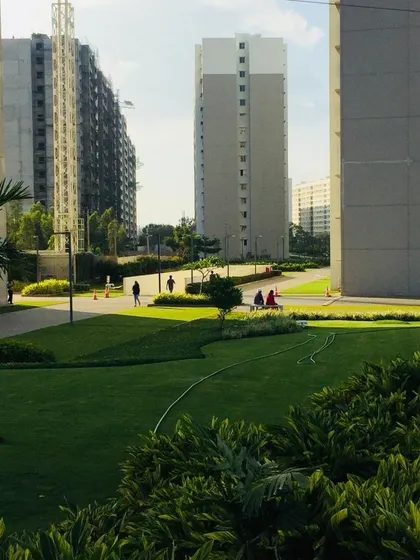 The view between two apartment towers, showing the expansive park-like setting we created for residents, complete with walking paths and lush greenery.