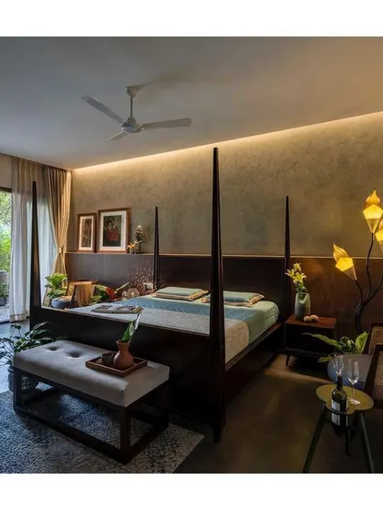 A four-poster bed adds a touch of classic elegance to this bedroom. The room opens onto a private terrace, extending the sanctuary space into the outdoors.
