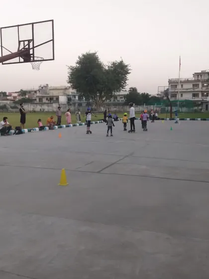 Another angle of the children's skating class, showing the spaciousness of the court which allows for safe practice.