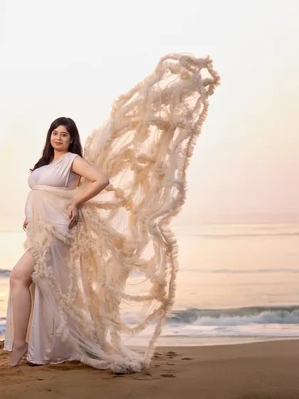 Another angle of the beautiful butterfly-wing gown, showing its versatility for creating different artistic looks during a single beach session.