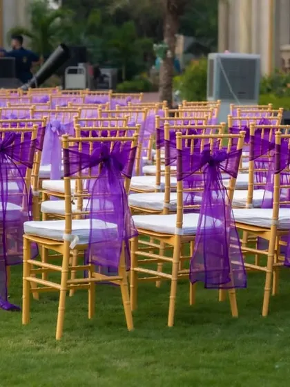 The guest seating was made elegant with gold Chiavari chairs decorated with beautiful purple sashes, perfectly matching the event's color scheme.