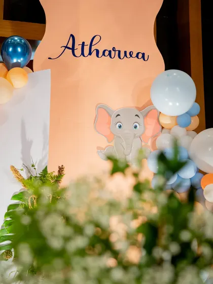 A glimpse of the cute elephant theme for Atharva's birthday. Even a simple, elegant backdrop can make a big impact, and we make sure to capture these stylistic details.