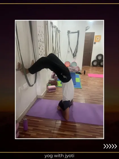 A powerful demonstration of Vrishchik Asana (Scorpion Pose) against the wall, showcasing advanced strength and flexibility.