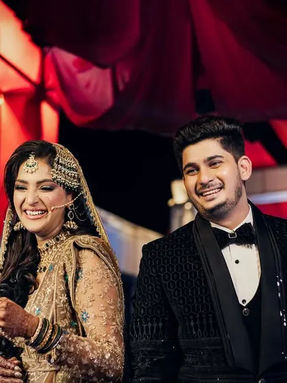 The first moments of laughter as a married couple. This candid shot captures their genuine joy and excitement during the wedding reception.