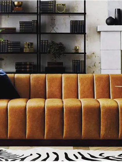 This sofa in a warm tan velvet features vertical channel tufting for a touch of retro elegance. The single-seat cushion and clean lines give it a sleek, contemporary profile, making it a sophisticated centerpiece for any living room.