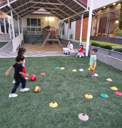 A player skillfully maneuvers the ball during a practice session. The image captures the focus and determination we nurture in our young athletes.