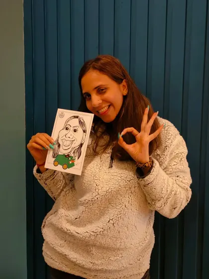 Her "okay" sign and bright smile show that the caricature was a big hit at this corporate event.