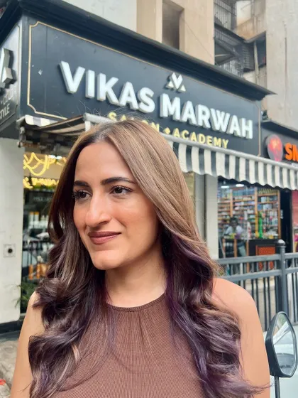 The client enjoying her new look just outside our Oshiwara salon. The color looks fantastic in the natural light.