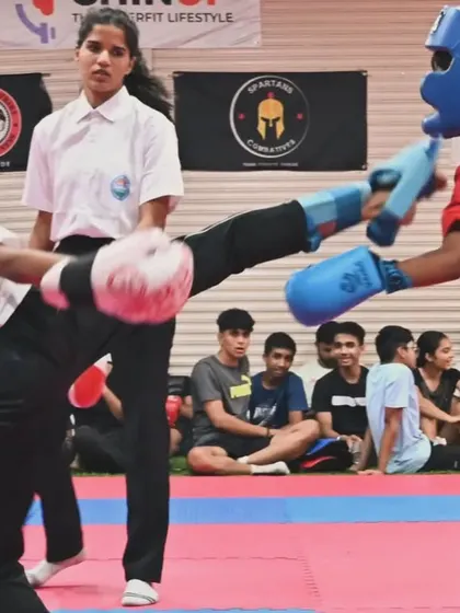 Precision in action. Here, one of our kickboxing students executes a powerful high kick during a competitive match. Our training focuses on developing the speed, technique, and confidence needed to perform effectively under pressure.