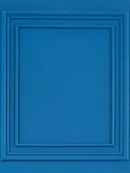 A simple yet effective detail: using molding to create framed panels on a bold blue wall.