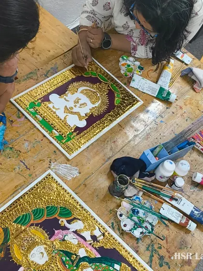 Our studio table with multiple Tanjore paintings being worked on simultaneously. This image captures the communal and creative energy of our adult art classes.