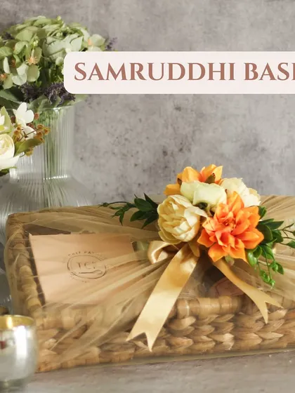 Our Samruddhi Basket is a rectangular handcrafted basket that is both rustic and chic. We wrap it in delicate netting and adorn it with flowers for a beautiful finish.