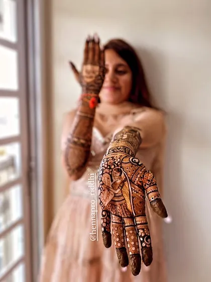 One of my beautiful brides. This portrait shot with the henna-covered hand in the foreground is a classic and creative way to showcase the final artwork.