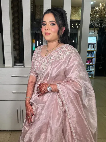 Another angle of this gorgeous party look. The high ponytail and soft pink makeup create a chic and modern style.