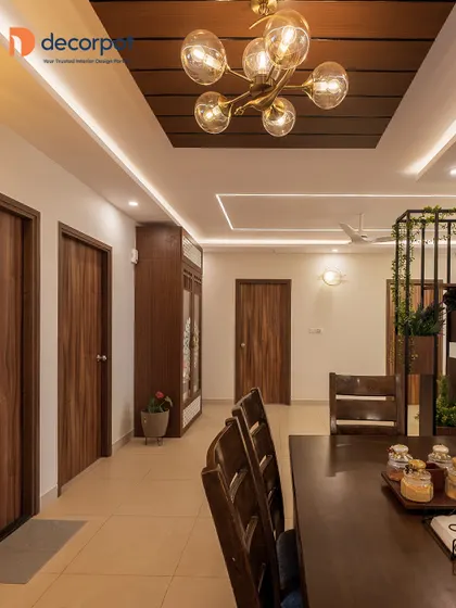 A view of a dining area adjacent to the kitchen, featuring a dark wood dining table and a stunning pendant light. The design shows how I create a cohesive flow between cooking and dining spaces.