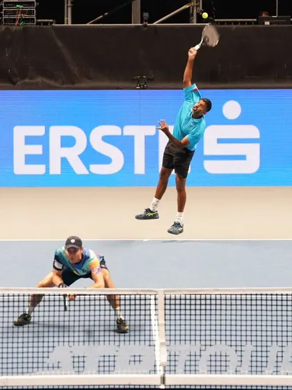 A coordinated jump serve and net position in doubles.