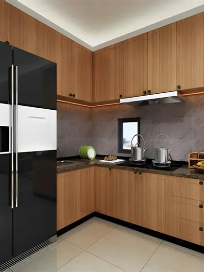 This kitchen design features warm wood cabinetry and a dark grey backsplash. The large, glossy black refrigerator is integrated to become a statement piece in the overall design.