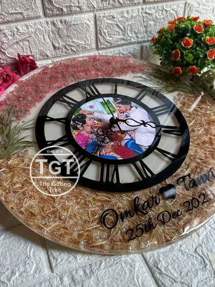 This large 16-inch clock was a special request to preserve a mix of different flowers from a wedding. The black Roman numeral dial provides a modern contrast to the natural elements.