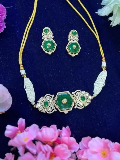 A unique and modern choker design. This piece features a hexagonal emerald-colored stone set in a delicate frame of American Diamonds, perfect for a chic, contemporary look.