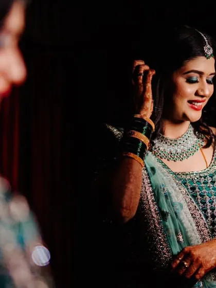 A beautiful reflection of a happy client. The CZ jewellery adds a touch of glamour to her reception look, and her smile says it all.