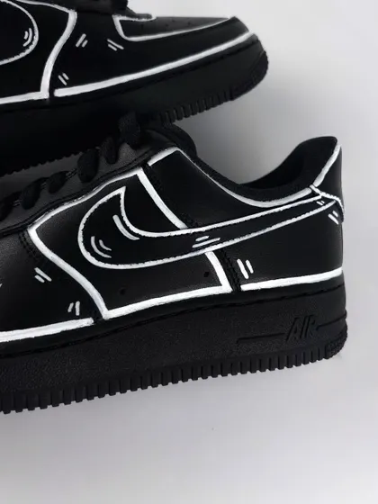 A detailed shot of the white outlines on the black cartoon custom sneaker.