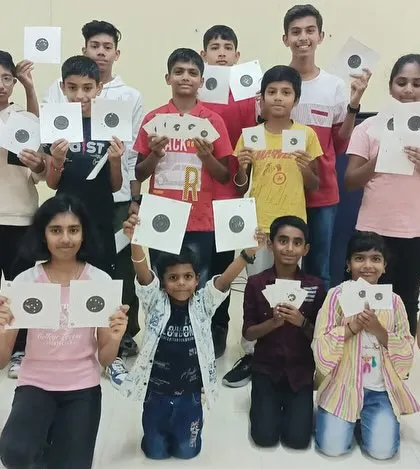 The proud result of a group shooting session for kids. It's rewarding to see them learn a new skill and show off their target practice results with a smile.
