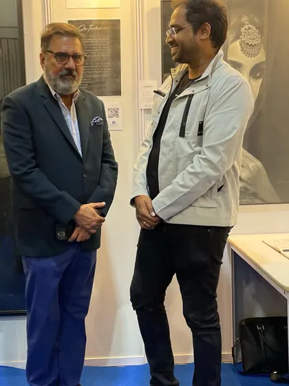 Sharing a pleasant moment with a visitor at my exhibition booth.
