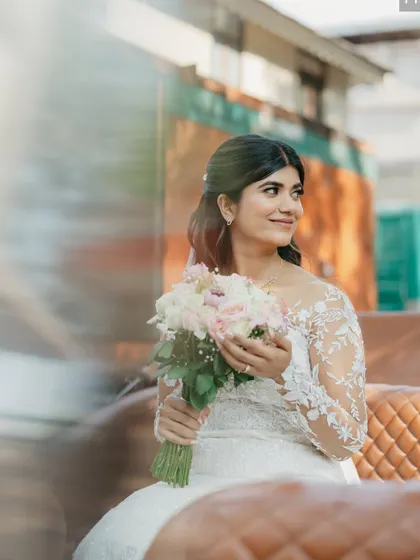 A fairytale moment. Seated in a carriage, this bride looks absolutely breathtaking with her soft makeup and elegant hairstyle.