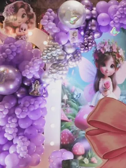 A closer look at the details of our purple fairy theme. The setup features dense balloon clusters, character cutouts, and a large decorative bow, all coming together to create a rich and immersive party environment.