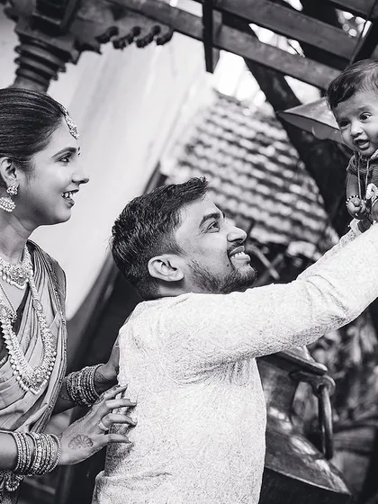 A joyful family moment captured in black and white, as the father lifts his baby high. We believe these unposed shots truly reflect a family's love.