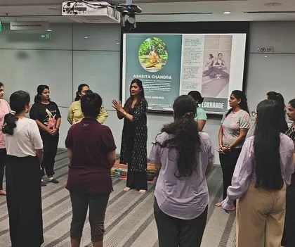 Group exercises in a circle can build a sense of team unity and connection. Here, I am leading the ABB team in a simple standing movement to warm up the body and break the ice.