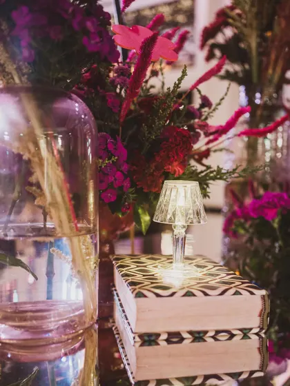 A close-up of a tiny crystal lamp placed on a stack of books, demonstrating how small, thoughtful details can elevate the entire decor.