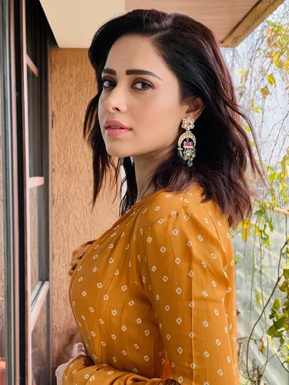 The details on the earrings and the texture of the fabric are highlighted in this close-up. Accessorizing is key to personalizing any look.