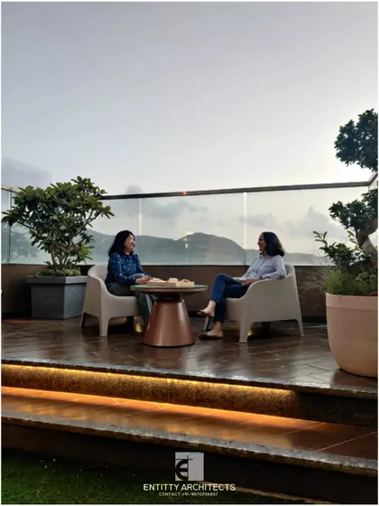 Here you can see the second terrace of the same penthouse, designed for enjoying the scenic view. We used a simple wooden deck and a clear glass railing to keep the focus on the landscape. This space shows how we create functional outdoor seating areas perfect for quiet moments or conversations.