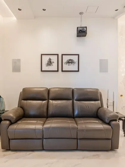 Another view of the home theater, showing its connection to the rest of the home via the grand staircase. The design allows the space to feel both separate and integrated.