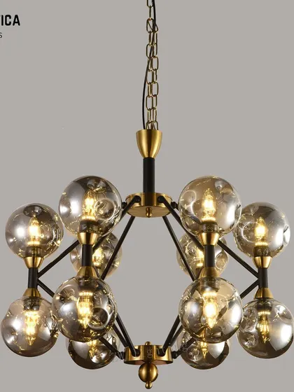 This modern chandelier features a cluster of smoked glass spheres. The design offers beautiful ambient lighting and adds a touch of contemporary elegance to any room's decor.