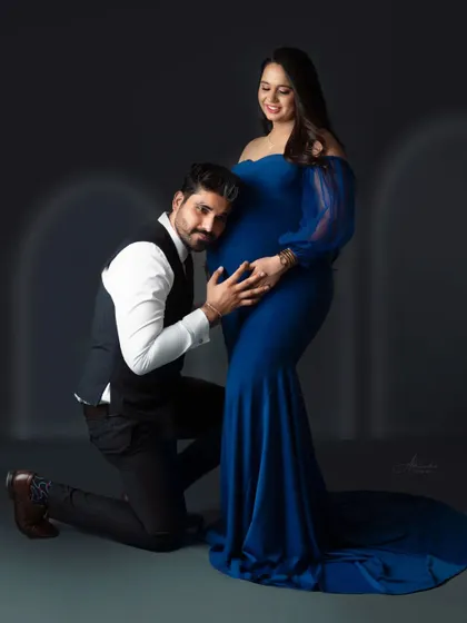 Listening for a heartbeat. This pose is always full of emotion, capturing the dad-to-be's excitement and connection with his baby.