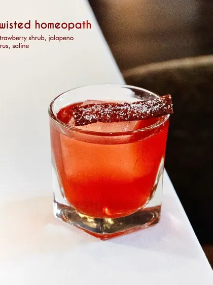 The Twisted Homeopath is a bold and unconventional creation. We blend whisky with a house-made strawberry shrub and a surprising hint of jalapeno brine, resulting in a complex cocktail that is equal parts sweet, savory, and spicy.