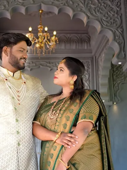 A close-up of the couple from their royal-themed pre-wedding shoot, showcasing their traditional attire and the opulent surroundings.