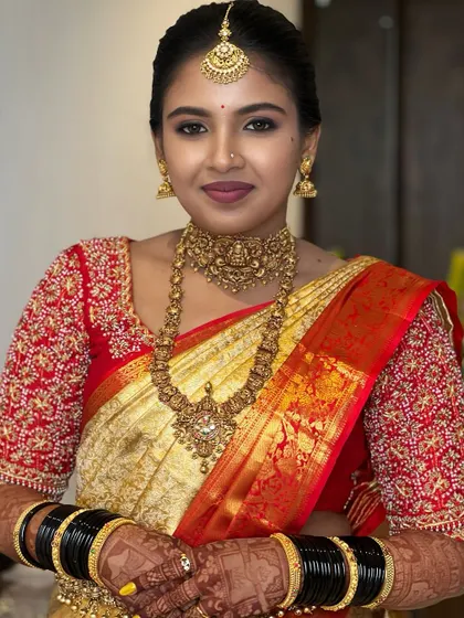 A dazzling bride in red and gold. This look is completed with a traditional South Indian braid, blending heritage with timeless beauty.