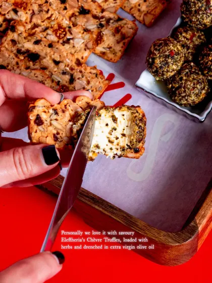 A close-up of the perfect pairing. The savoury notes of the Chèvre Truffle cut through the sweetness of the Fruit 'N' Nut Crisps for a balanced bite.