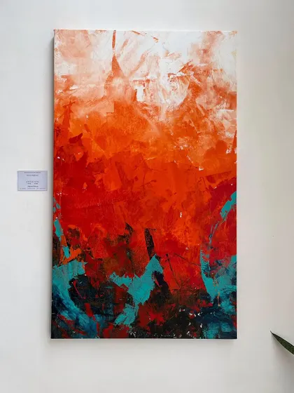 Another view of 'The Uprising' on display. The artwork's fiery colors create a warm and energetic focal point in the room.