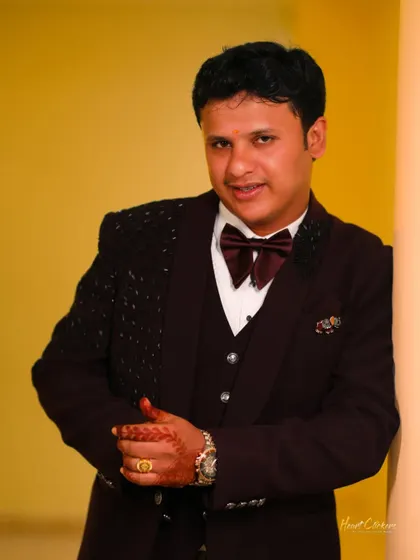 A classic portrait of the groom looking sharp in his reception suit.