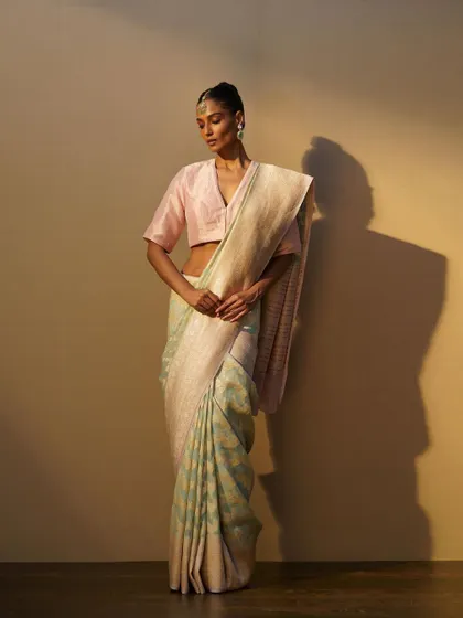 The same pastel handwoven saree, styled to show its delicate texture and beautiful fall.