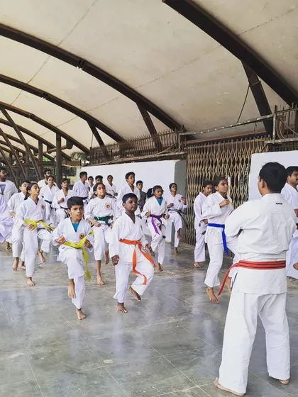 A typical Kyu Grading session at our main Malleshwaram dojo. An instructor leads the class through fundamental drills, a key part of every belt exam.