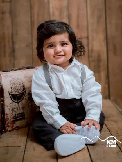 This little gentleman is ready for his portrait. The sitter session is perfect for capturing those emerging personalities and sweet smiles.