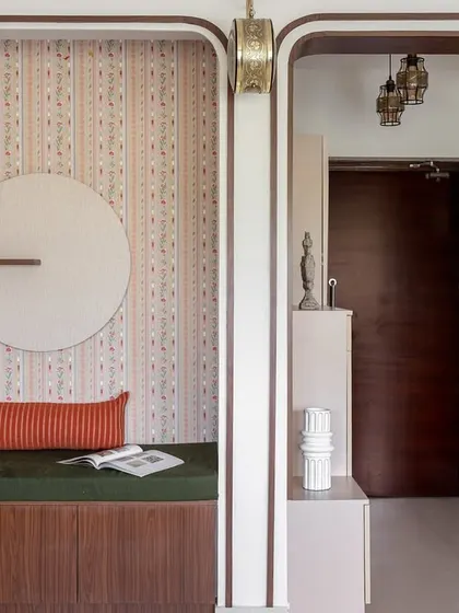 An existing niche in the living room was transformed into this cozy reading alcove with a built-in bench and storage. The patterned wallpaper and arched frame add a playful yet elegant touch.
