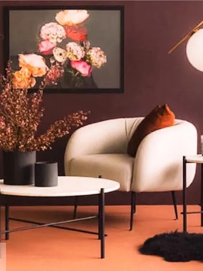 This cozy white armchair, with its soft curves and inviting shape, is perfect for a quiet corner. Paired with modern marble-top side tables, it creates a sophisticated and comfortable spot for reading or enjoying a cup of coffee.