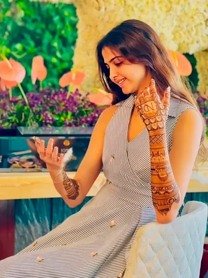 A beautiful, candid shot of the bride admiring her personalized mehndi design.