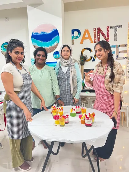 A group of friends enjoying a weekend candle making session and showing off their colorful creations.